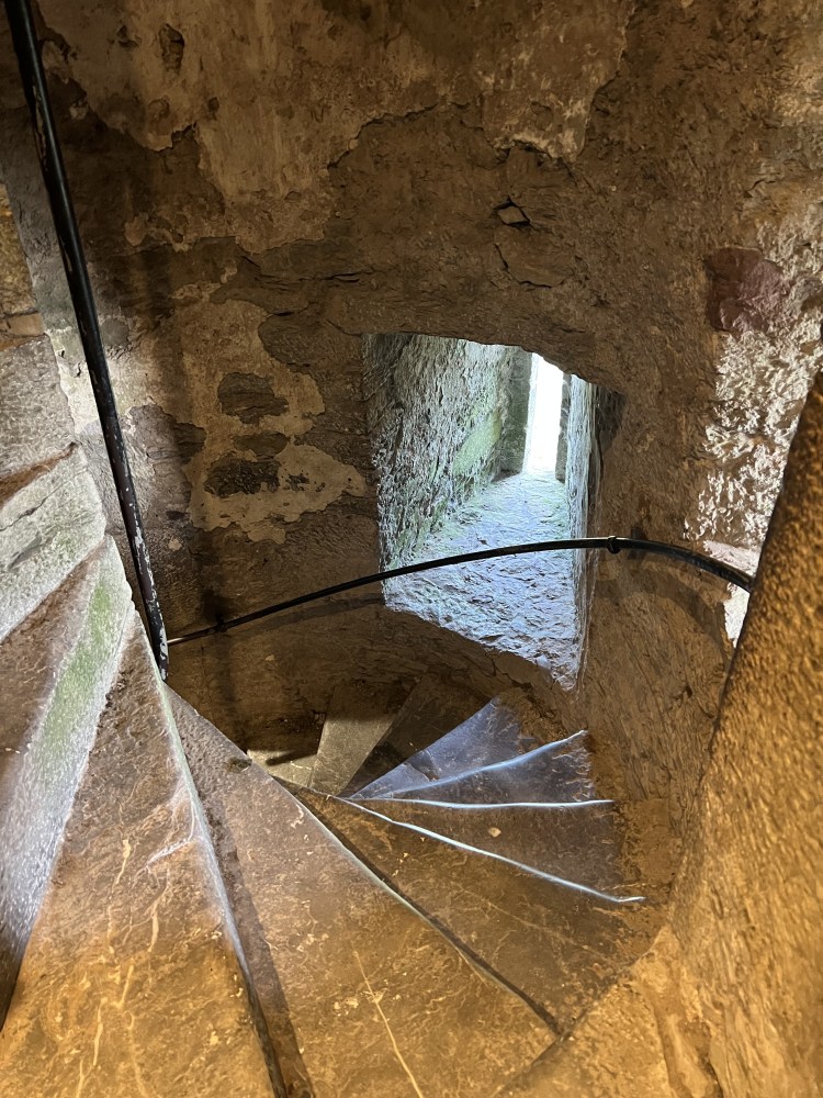 Castle stairs are narrow spirals of rock, making it hard for the enemy to fight their way up where the family hid. Very hard to climb.